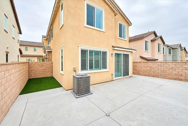 back of property featuring a patio and central AC unit