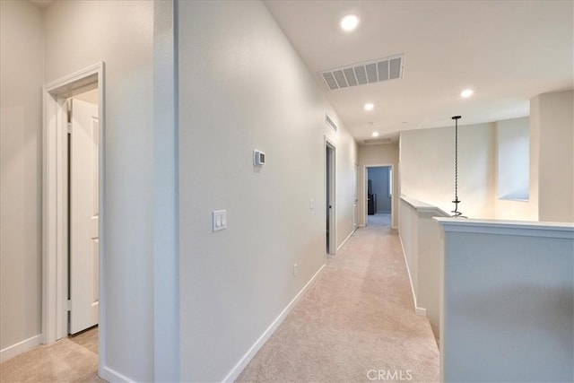 hallway featuring light carpet