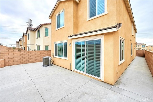 back of property featuring cooling unit and a patio area