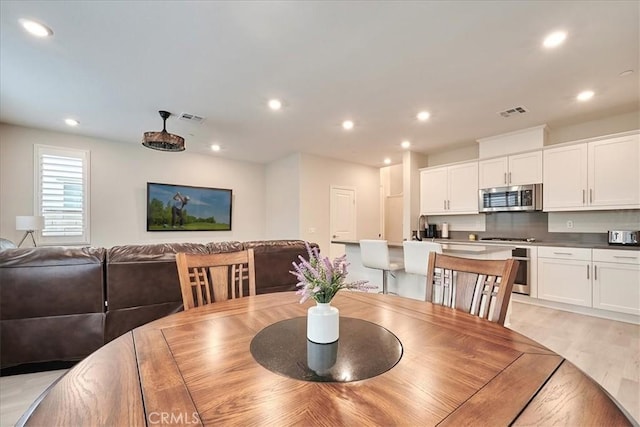 dining area with light hardwood / wood-style floors