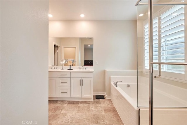 bathroom featuring vanity and plus walk in shower