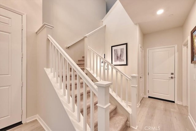 stairway with hardwood / wood-style flooring