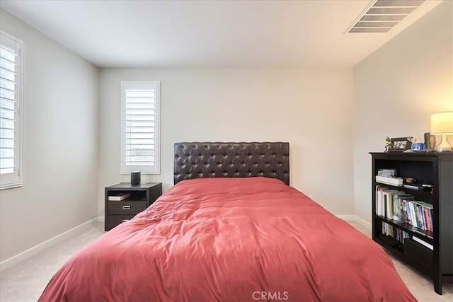 bedroom with light colored carpet