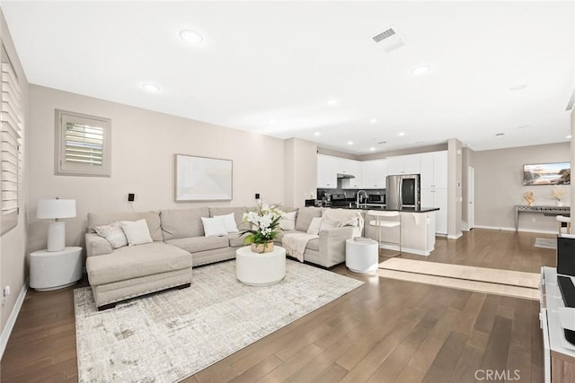 living room with sink and dark hardwood / wood-style flooring