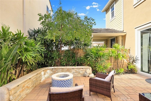 view of patio featuring an outdoor fire pit