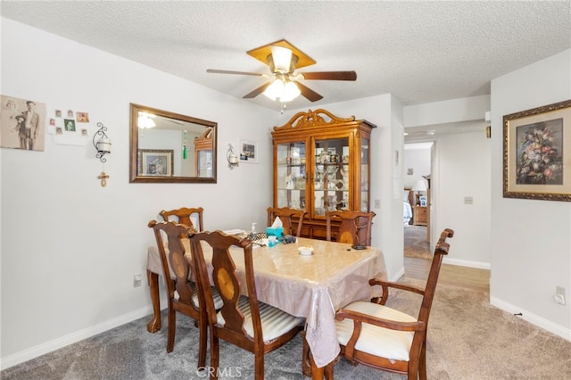 dining space featuring ceiling fan, a textured ceiling, and carpet flooring