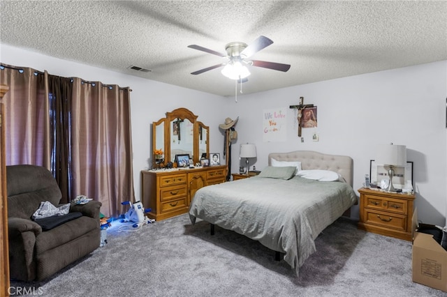 bedroom featuring ceiling fan, carpet, and a textured ceiling