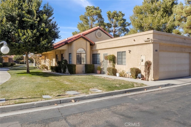 view of front of house with a garage and a front lawn