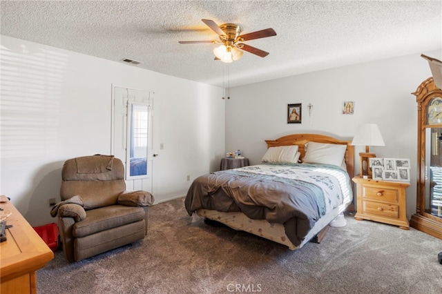 carpeted bedroom featuring a textured ceiling and ceiling fan