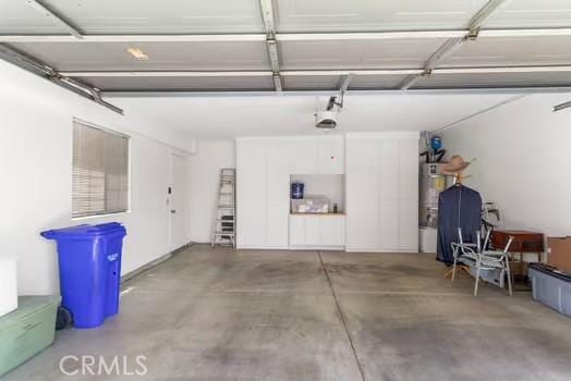 11636 Kerrie Way, Apple Valley, CA 92308 - garage with water heater and a garage door opener
