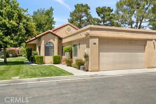 11636 Kerrie Way, Apple Valley, CA 92308 - mediterranean / spanish house featuring stucco siding, a garage, a front yard, and driveway