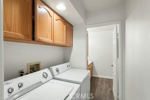 11636 Kerrie Way, Apple Valley, CA 92308 - laundry room featuring separate washer and dryer, cabinet space, dark wood finished floors, and baseboards