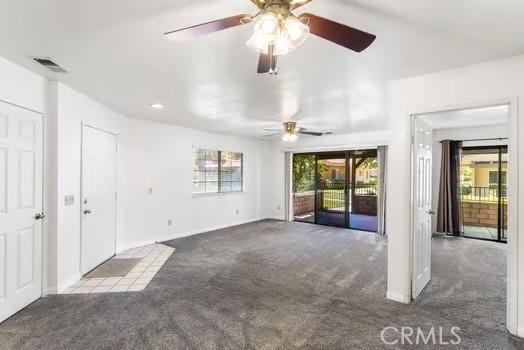 11636 Kerrie Way, Apple Valley, CA 92308 - unfurnished living room with carpet, healthy amount of natural light, a ceiling fan, and recessed lighting