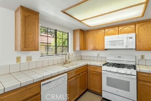 11636 Kerrie Way, Apple Valley, CA 92308 - kitchen featuring white appliances, a sink, brown cabinets, and tile countertops