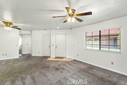 11636 Kerrie Way, Apple Valley, CA 92308 - unfurnished living room with a ceiling fan, baseboards, and carpet floors