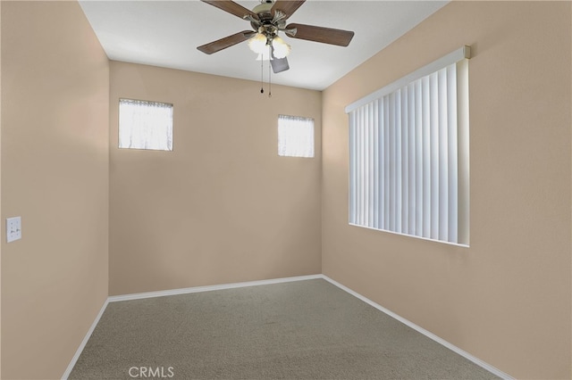 empty room with ceiling fan and carpet flooring