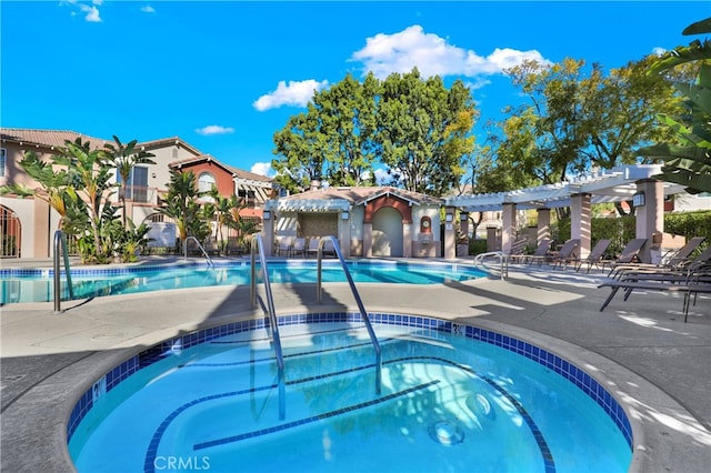 view of swimming pool with a hot tub and a pergola