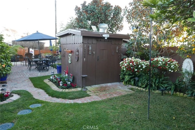 view of yard featuring a storage shed and a patio area