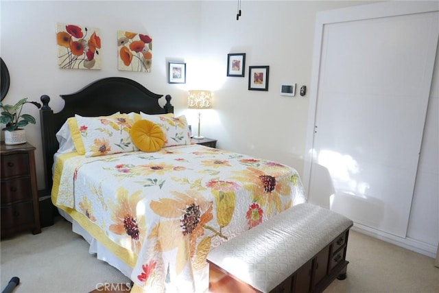 bedroom featuring light colored carpet