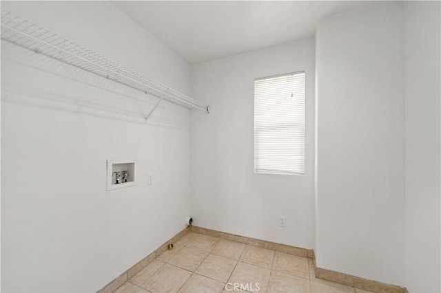 laundry room featuring washer hookup and light tile patterned floors