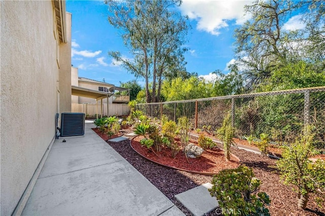 view of yard featuring central AC unit and a patio area