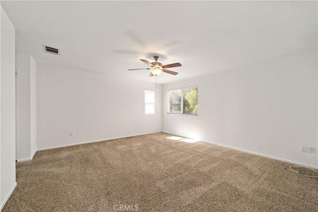 unfurnished room featuring ceiling fan and carpet flooring