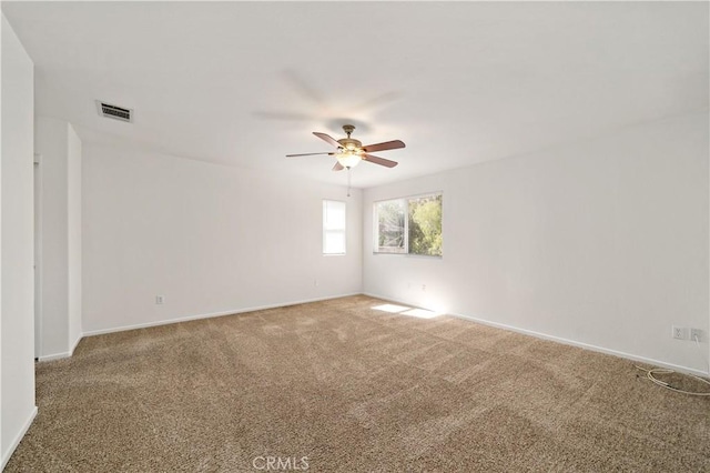 spare room with carpet and ceiling fan