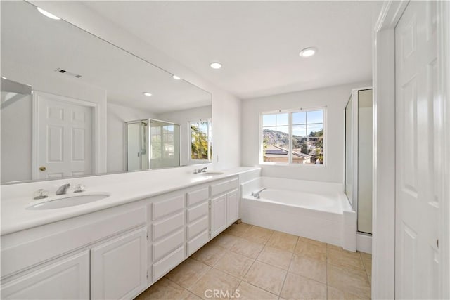 bathroom with independent shower and bath, vanity, and tile patterned floors