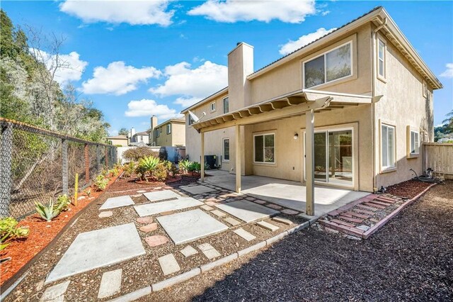 back of property featuring cooling unit and a patio