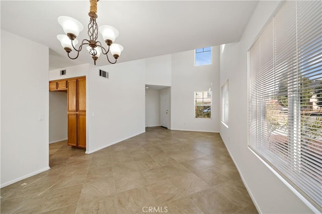 unfurnished room with a chandelier