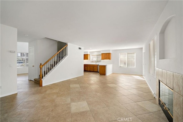 unfurnished living room featuring light tile patterned flooring