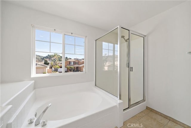 bathroom with independent shower and bath and tile patterned flooring