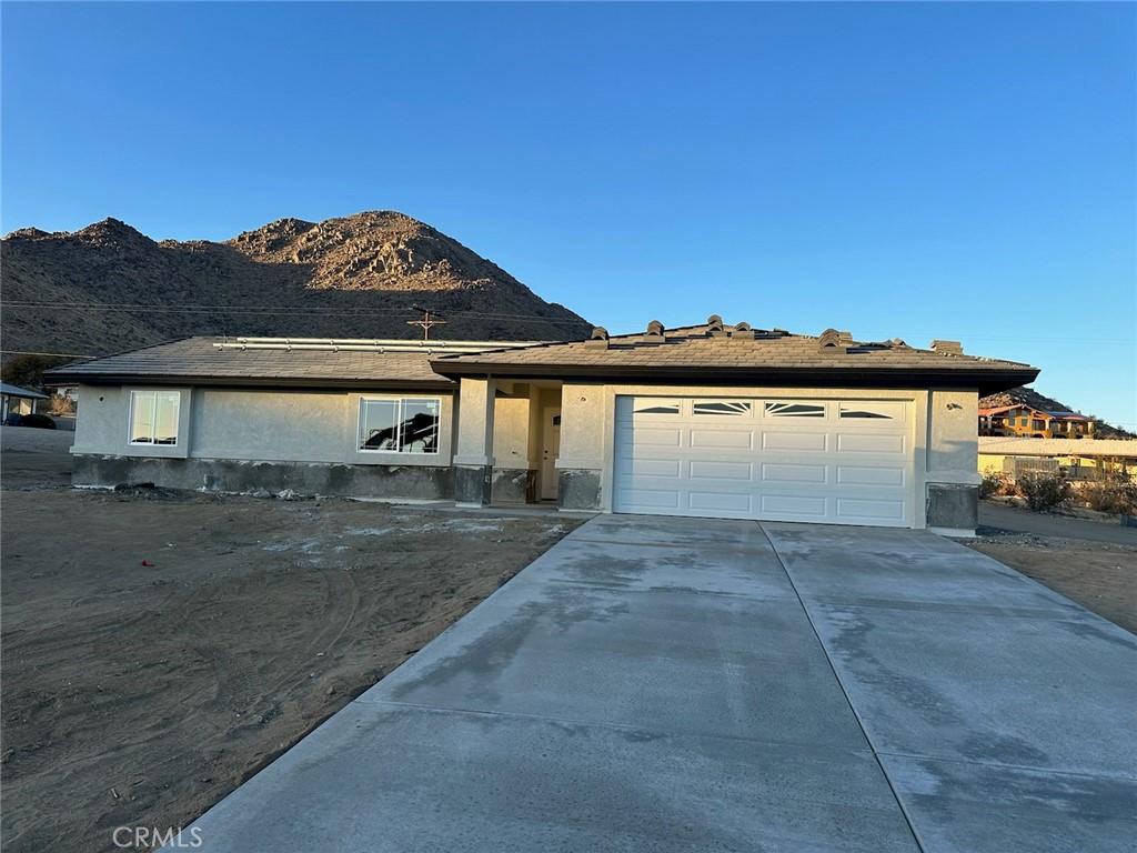 view of front facade with a mountain view and a garage