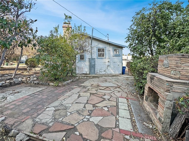 back of property with a patio and a chimney