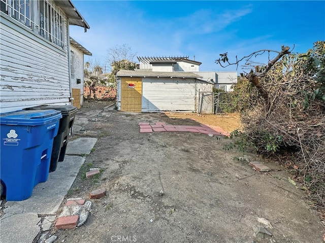 view of yard with a garage and an outdoor structure