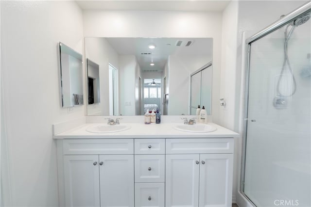 bathroom featuring walk in shower and vanity