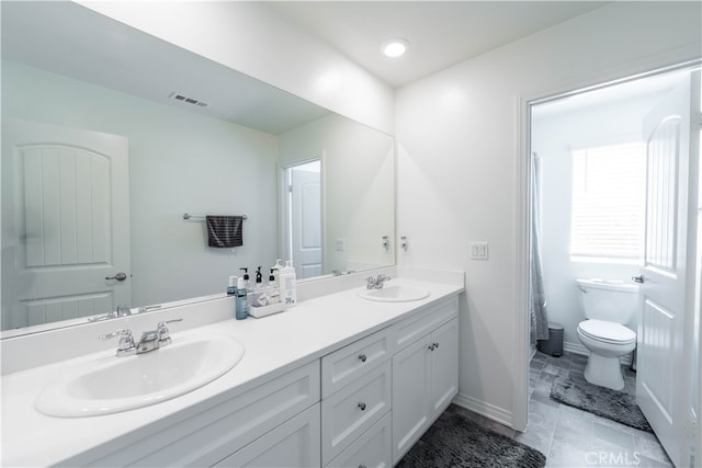 bathroom with toilet and vanity