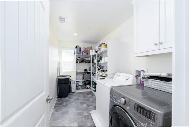 washroom featuring cabinets and independent washer and dryer