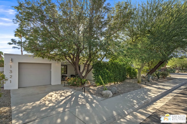 obstructed view of property with a garage