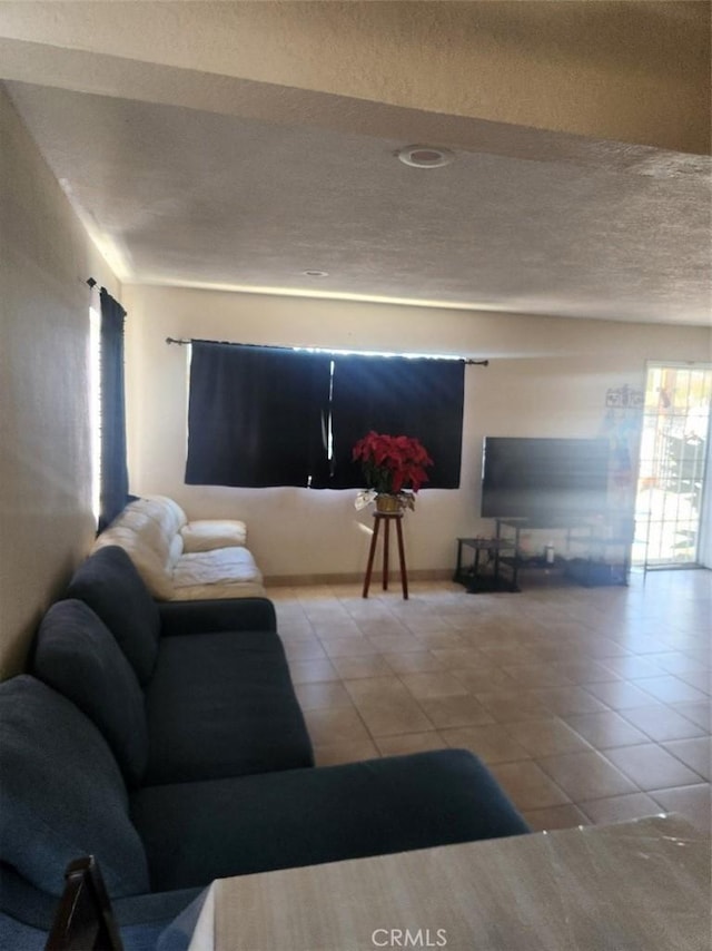 living room with light tile patterned floors and a textured ceiling