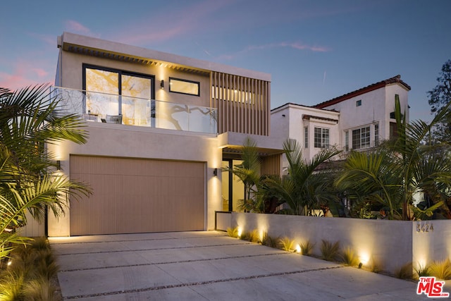 view of front of house featuring a garage and a balcony