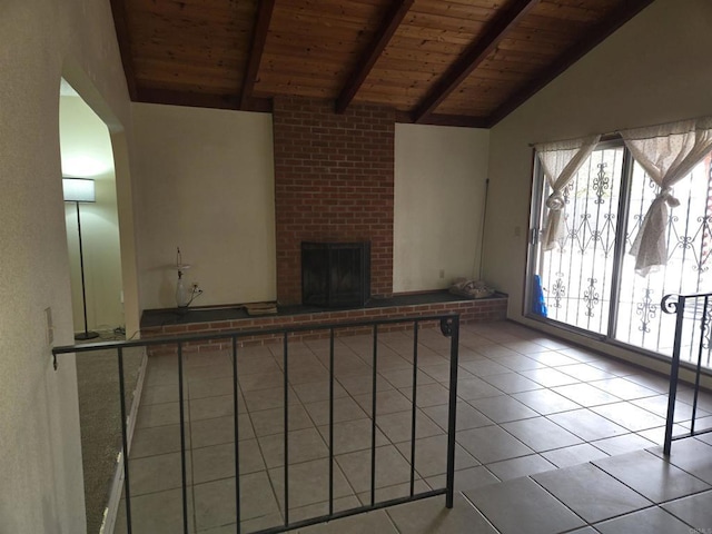 unfurnished living room featuring a brick fireplace, lofted ceiling with beams, wood ceiling, and light tile patterned flooring