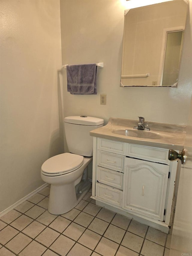 bathroom featuring toilet, vanity, and tile patterned floors