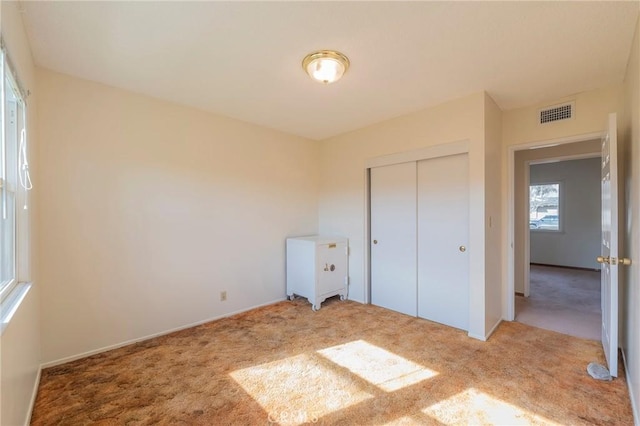 unfurnished bedroom featuring a closet and carpet