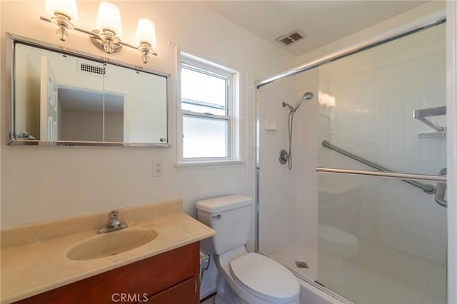 bathroom featuring vanity, toilet, and walk in shower