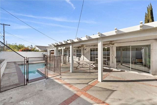 exterior space with ceiling fan and a fenced in pool