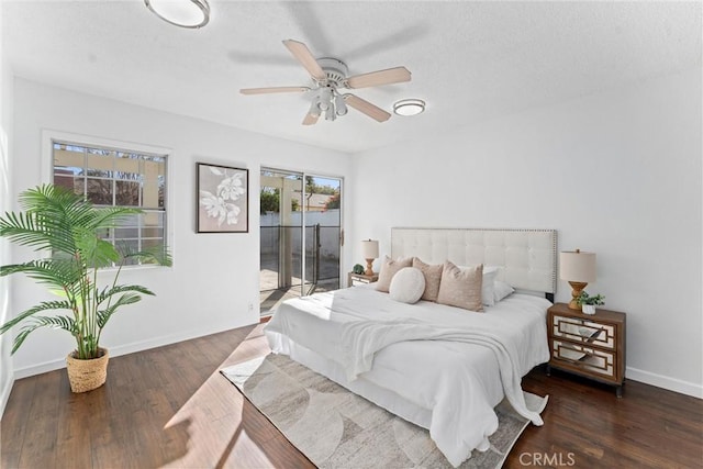 bedroom with ceiling fan, dark hardwood / wood-style floors, multiple windows, and access to outside