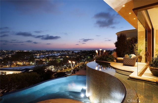 view of pool at dusk