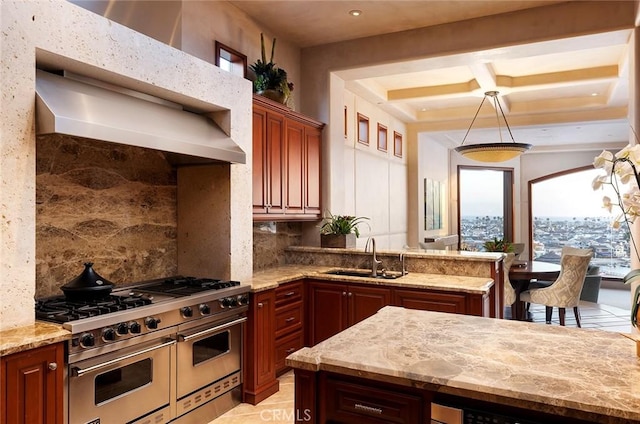 kitchen with light stone countertops, double oven range, backsplash, and sink