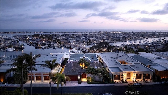 aerial view at dusk with a water view